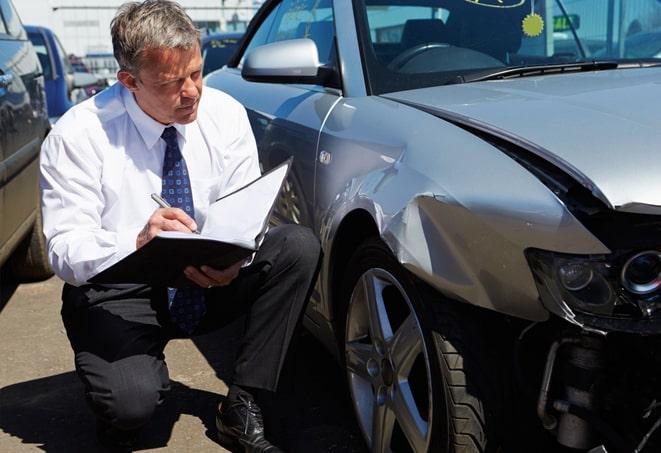 gray car with insurance documents on dashboard